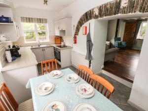 a kitchen and dining room with a table and chairs at Barn Cottage in Spittal