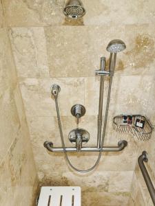 a shower in a bathroom with a stone wall at Omni Tucson National Resort in Tucson