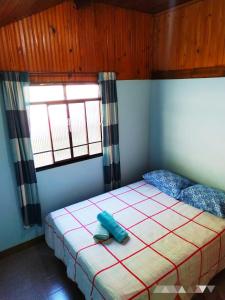 a bedroom with a bed and two windows at POUSADA DO BAR- BUDO in Visconde De Maua +67 photos