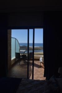 a room with a view of the ocean through a window at Auberge Oualidia Dream in Oualidia