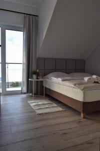 Postel nebo postele na pokoji v ubytování Rewianka Apartamenty przy samej plaży