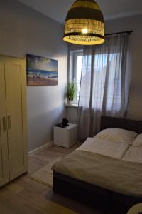 Postel nebo postele na pokoji v ubytování Rewianka Apartamenty przy samej plaży