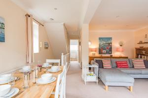 a living room with a couch and a table at The Landing in Hythe