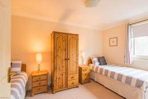 a bedroom with two beds and a window at The Landing in Hythe
