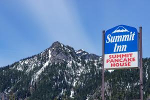 a sign in front of a mountain at The Summit Inn in Snoqualmie Pass