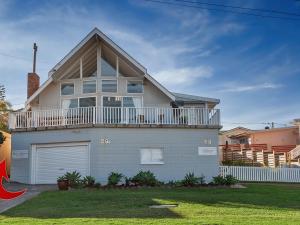 a large white house with a large balcony at Little Kingsley Beach House in Boat Harbour
