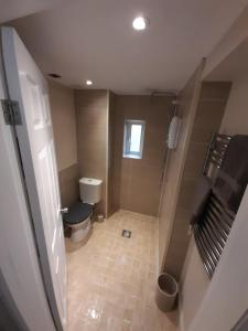 an overhead view of a bathroom with a toilet and shower at Stable cottage cozy,quirky with a hot tub in Bridlington +42 photos