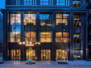 a large black building with lights in the windows at Granbell Hotel Osaka in Osaka
