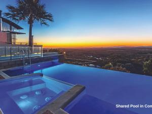 a swimming pool on top of a house with a sunset at One Mile Ridge No 15 in Boat Harbour