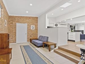 a living room with a couch and a door at Blue Fish 41 Boulder Bay Road in Fingal Bay