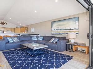 a living room with a couch and a table at Beach House 72A Marine Dr Fingal Bay in Fingal Bay
