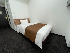 Postel nebo postele na pokoji v ubytování Ueno Urban Hotel Annex