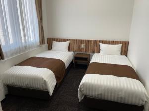 Postel nebo postele na pokoji v ubytování Ueno Urban Hotel Annex