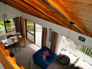an overhead view of a living room with a table and chairs at Bush Henge - Tata Beach Holiday Home in Tarakohe