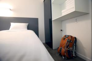 Postel nebo postele na pokoji v ubytování KSTAR METRO Hotel