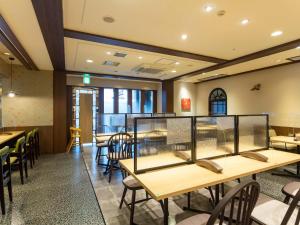 a restaurant with tables and chairs in a room at Hotel Belleview Nagasaki Dejima in Nagasaki