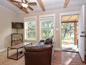 a living room with a couch and a table at Cabins at Flite Acres- Coyote Cabin in Wimberley