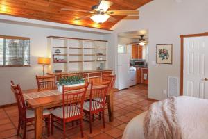 a kitchen and dining room with a table and chairs at Burnett Ranch Cabins- Rosemary in Wimberley