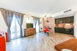 a kitchen with a red scooter in the middle of a room at Vespa Apartments in Moneglia