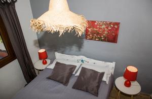 a bedroom with a bed with two tables and a chandelier at VILLA VICTORIA in Ditropo +43 photos