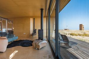 a living room with a view of the desert at El Ray by Bloom Stays in Dungeness