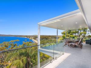 a view of the water from the balcony of a house at Randall Drive No 64 in Salamander Bay