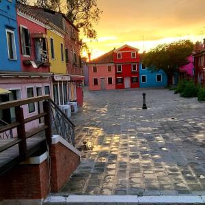 a city street with colorful buildings in the sunset at Burano Cà Comare in Burano
