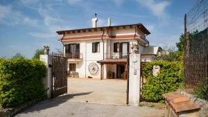 uma casa branca com um portão e uma cerca em L'Arcadia em Giffoni Sei Casali