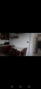 a kitchen with a table and chairs in a kitchen at La Fontana in Gallipoli +9 photos