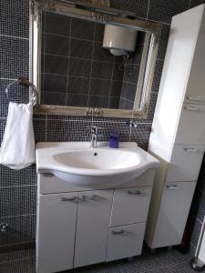 a bathroom with a sink and a mirror at Apartman Maja in Vodice +12 photos