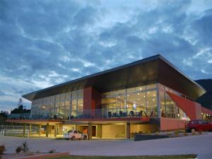 ein großes Gebäude mit auf einem Parkplatz abgestellten Autos in der Unterkunft Frasers Cottage in Laurieton