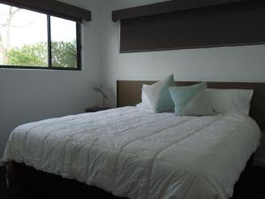 a bedroom with a large white bed with a window at Northern Haven Too North Haven in North Haven