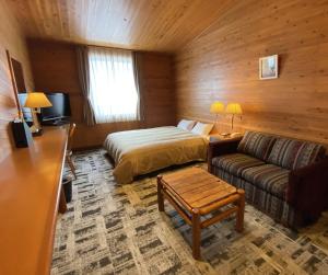 a hotel room with a bed and a couch at Kibi Kogen Resort Hotel in Kaga