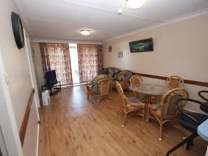 a living room with a table and chairs at Beachfront 3 Unit 3 of 12 Bundella Ave LC in Lake Cathie