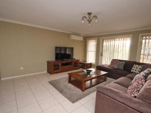a living room with a couch and a tv at North Heaven Station in North Haven