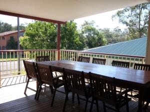a wooden table and chairs on a deck at North Heaven Station in North Haven