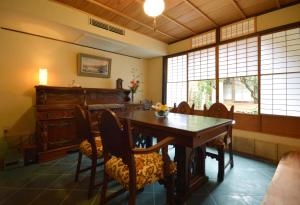 a dining room with a table and a piano at Jeugiya in Kyoto