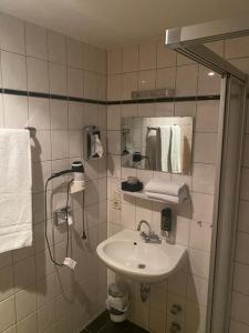 a bathroom with a sink and a mirror at Hotel Restaurant Frankenturm in Trier