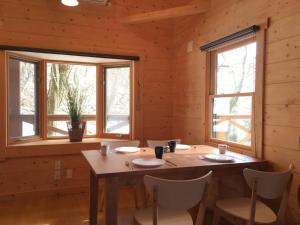 a dining room with a table and two windows at Trust Maison Shirada - Vacation STAY 18437v in Higashiizu