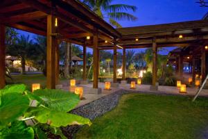 a pavilion with candles in a garden at night at Queena Plaza Hotel in Yongkang