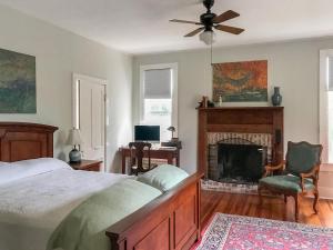 a bedroom with a bed and a fireplace at Yerba at Bastrop in Bastrop