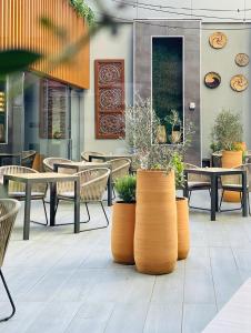 a patio with tables and chairs and plants at Riu Plaza New York Times Square in New York