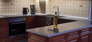 a kitchen with a sink and a wine glass on a counter at DREAM & HARMONY in Artemida +36 photos