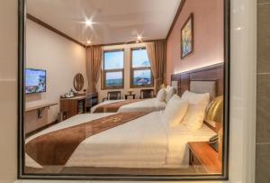 Postel nebo postele na pokoji v ubytování Marigold Hotel Dalat