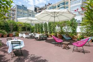 a patio with tables and chairs and umbrellas at Mihlton Barcelona Boutique B&B in Barcelona +66 photos