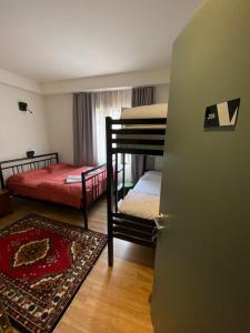 a room with two bunk beds and a door at Vanilla Sky Boutique Hostel in Tirana