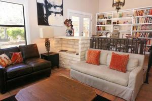 a living room with a couch and a fireplace at Deer Run- Creekhouse in Wimberley