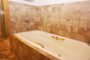 a bath tub with a banana sitting on top of it at Deer Run- Creekhouse in Wimberley +8 photos