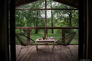 a table and two chairs on a wooden deck at Camping Le Mouliat in Moncrabeau