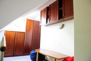 a kitchen with wooden cabinets and a wooden table at Apartments SOELEK - Vila Golf in Rogaška Slatina